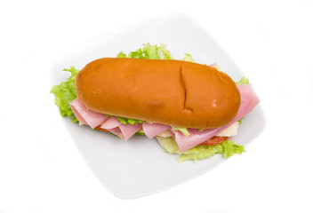 Sandwich with ham and salad on white background seen from above