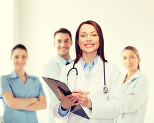 smiling female doctor with clipboard