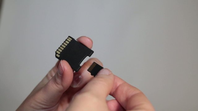 Slowly Sliding MicroSD Card Into MiniSD Adapter