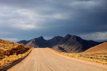dusty road in the mountainous landscape of central Namibia