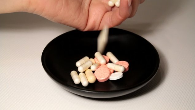 Dropping Medical Capsules Onto A Plate