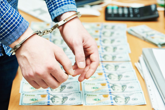 bribe concept. dollars and handcuffs