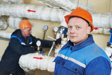 heating engineer repairmans in boiler room
