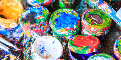 Fototapeta na wymiar Colorful paintbrushes and paint tanks