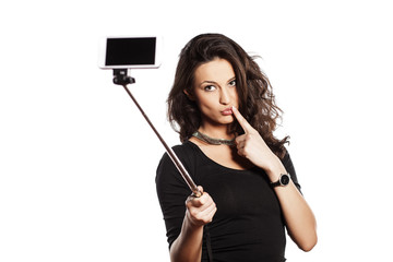 pretty brunette making selfie with a stick