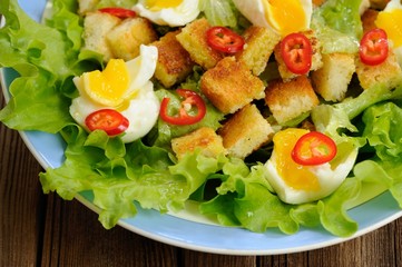 Salad Caesar with eggs, chili pepper closeup macro