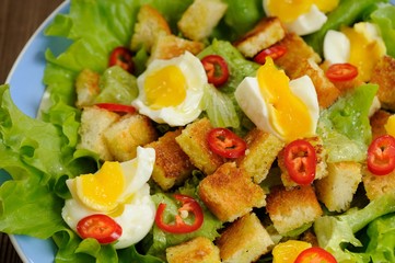 Salad Caesar with eggs, chili pepper closeup macro