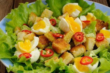 Salad Caesar with eggs, chili pepper closeup macro