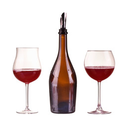 Red wine in bottle with dispenser two glasses isolated on white