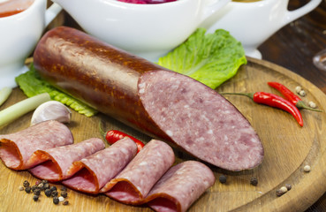 sausages on a wooden plate with vegetables in a restaurant