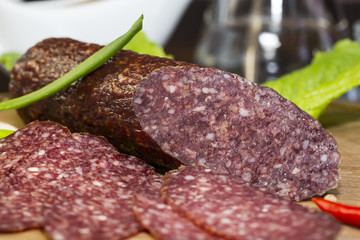 sausages on a wooden plate with vegetables in a restaurant