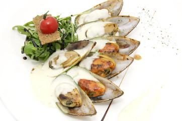 mussel sauce and greens on a white background