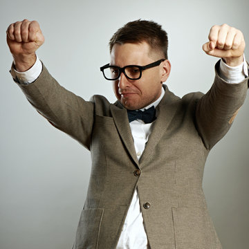 Confident nerd in eyeglasses and bow tie enjoying success