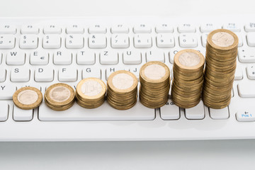 Stack Of Coins On Keyboard