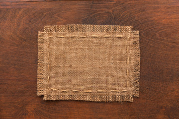 Frame of burlap, lies on a background of wood