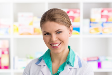 Close-up of woman pharmacist standing in retail drug store