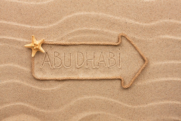 Arrow made of rope and sea shells with the word Abu dhabi on the
