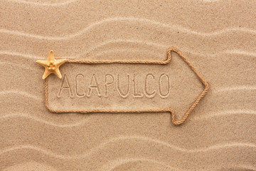Arrow made of rope and sea shells with the word Acapulco on the - 79748356