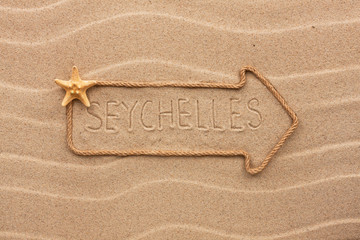 Arrow made of rope and sea shells with the word Seychelles on th
