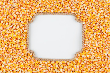 Figured frame made of rope with  corn  grains  lying on a white