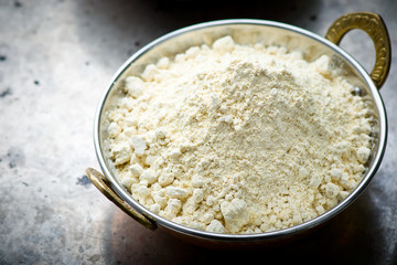 Flour from chick-pea in the Indian copper bowl