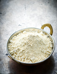 Flour from chick-pea in the Indian copper bowl