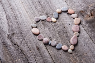 Stone heart on wooden table