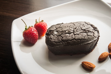 Dessert chocolate cake on a white plate.