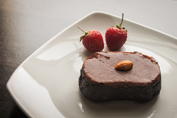 Dessert chocolate cake on a white plate.