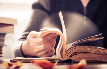 man scrolling old book pages