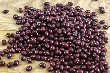 Red edible bean over wood.
