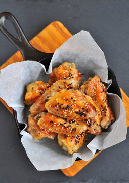 Chicken Wings In A Sweet And Sour Sauce With Sesame On The Pan