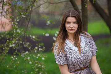 Portrait of young woman in old vintage dress in garden, prak in