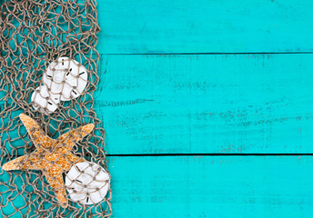 Blank teal blue sign with starfish and sand dollars in fish net border