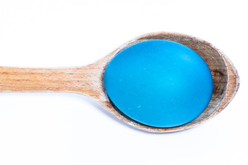 easter eggs and wooden spoon isolated on white