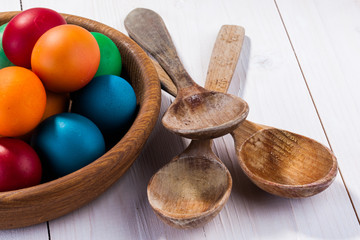 easter eggs and wooden plate isolated on white