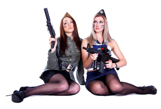 Two women in the military uniform with guns