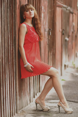 Naklejka premium Urban portrait of a barefoot girl with high heels