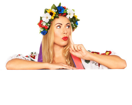 Attractive woman wears Ukrainian national dress behind board