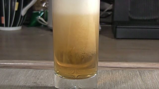 brimming with light beer glass closeup