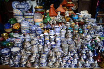 Colorful faience pottery dishes and tajines on display in Morocc