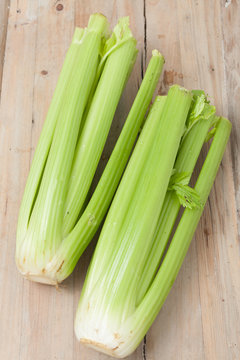 organic celery stalks on wooden background