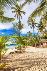 Fototapeta na wymiar Cheap bungalows on a tropical beach