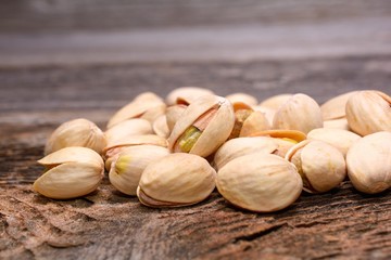 Roasted pistachios on wooden background