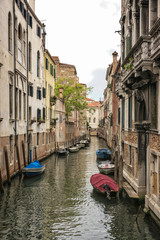 Fototapeta na wymiar Long narrow straight channel in Venice
