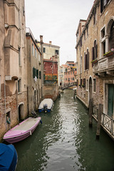 Narrow channel with citizen boats in Venice