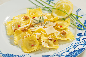 Piatto di ravioli al pepe rosa,noci e scaglie di grana