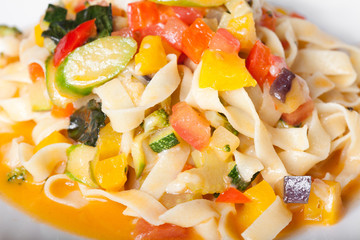 pasta with vegetables on a white plate