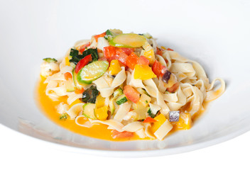 pasta with vegetables on a white plate