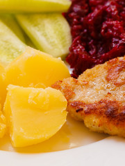 Dinner meal. Fried chicken potatos salad on plate.